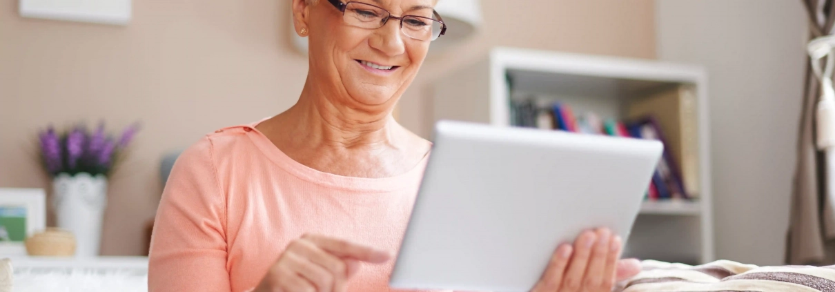 Senior mettant à jour son ordinateur et sa tablette en toute sécurité