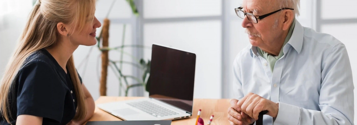 Senior accompagné par une conseillère pour comprendre simplement son contrat d’assurance